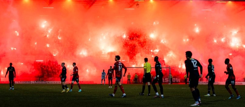 rangers fans celebrate with pyro at dens park