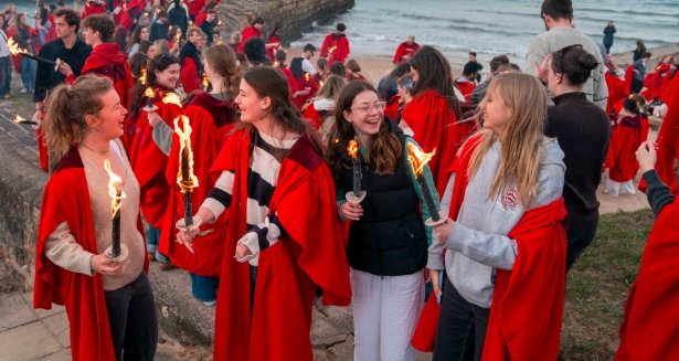 students wearing red gowns at University of St Andrews Scotland procession
