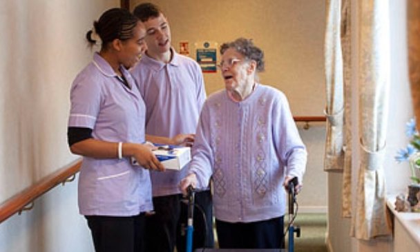 Scottish care home corridor elderly woman walker