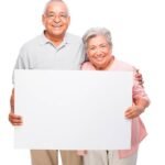 elderly woman holding sign