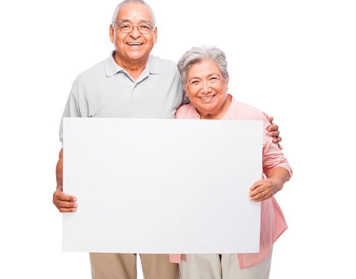 elderly woman holding sign