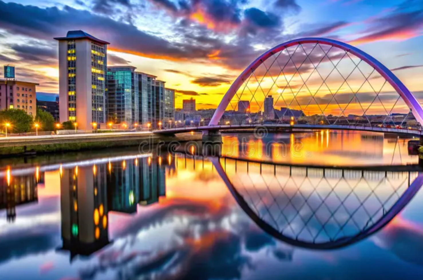 Glasgow city skyline Clyde Arc bridge at sunset reflection