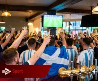 Scotland fans Glasgow pub celebrate Argentina beating England World Cup