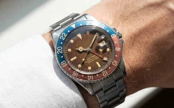 patinaed vintage wristwatch dial under natural daylight